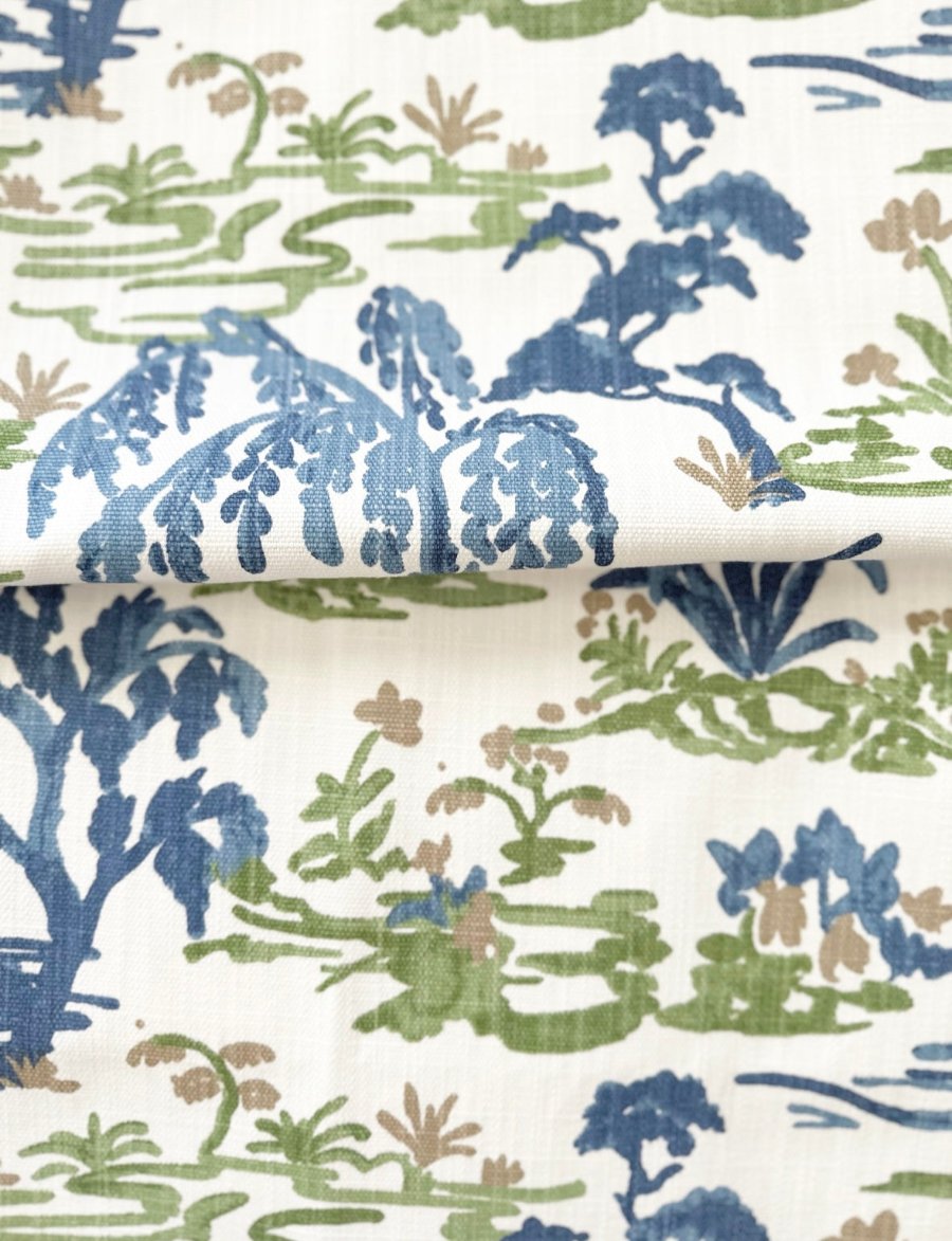 Meadow fabric with a green and blue print, ideal for creating custom throw pillows or home decor with a vibrant and natural look