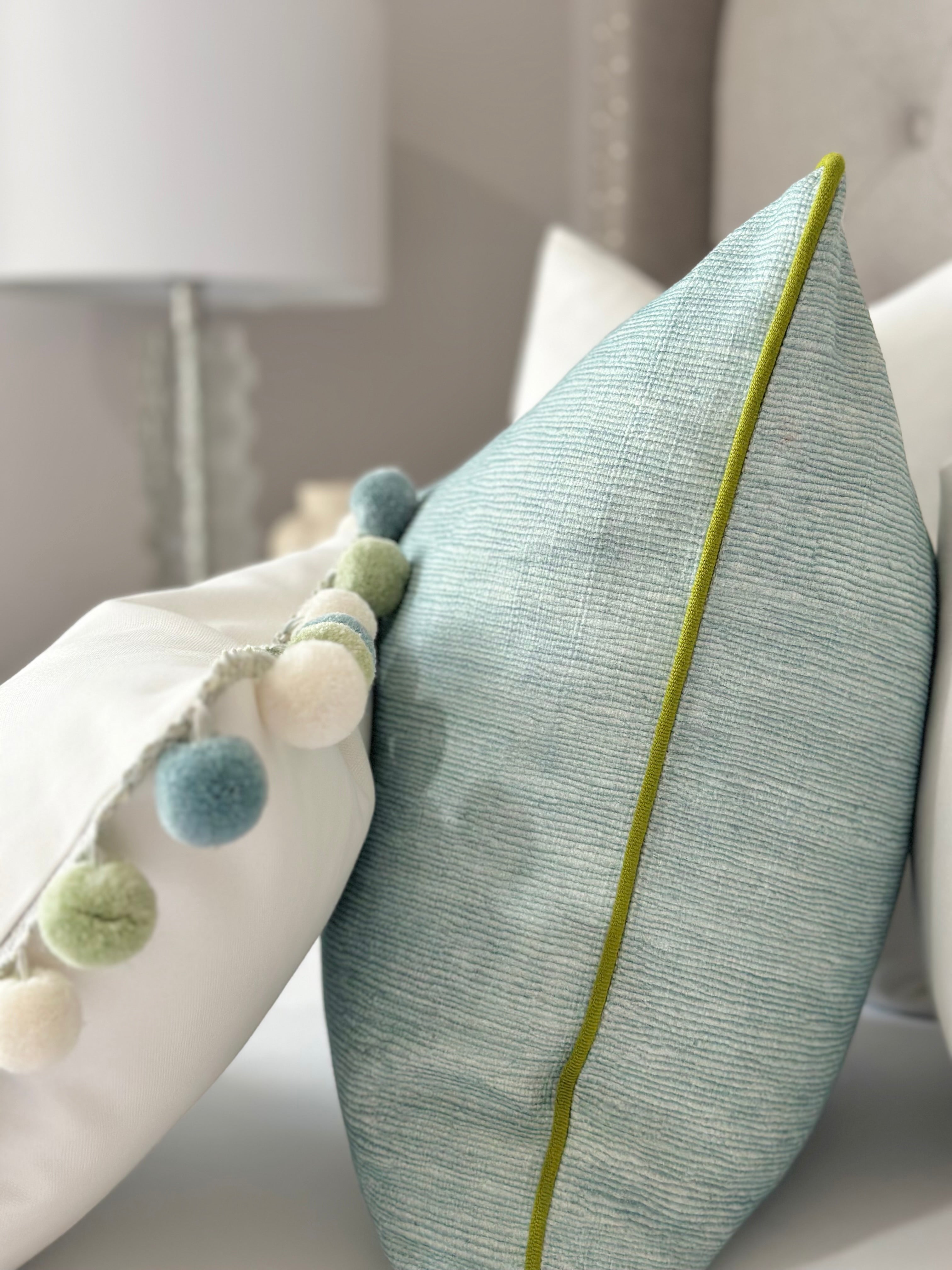 High-quality seaglass pillow cover with green trim, ideal for coastal living room decor, combining elegance and durability for a luxurious home accent