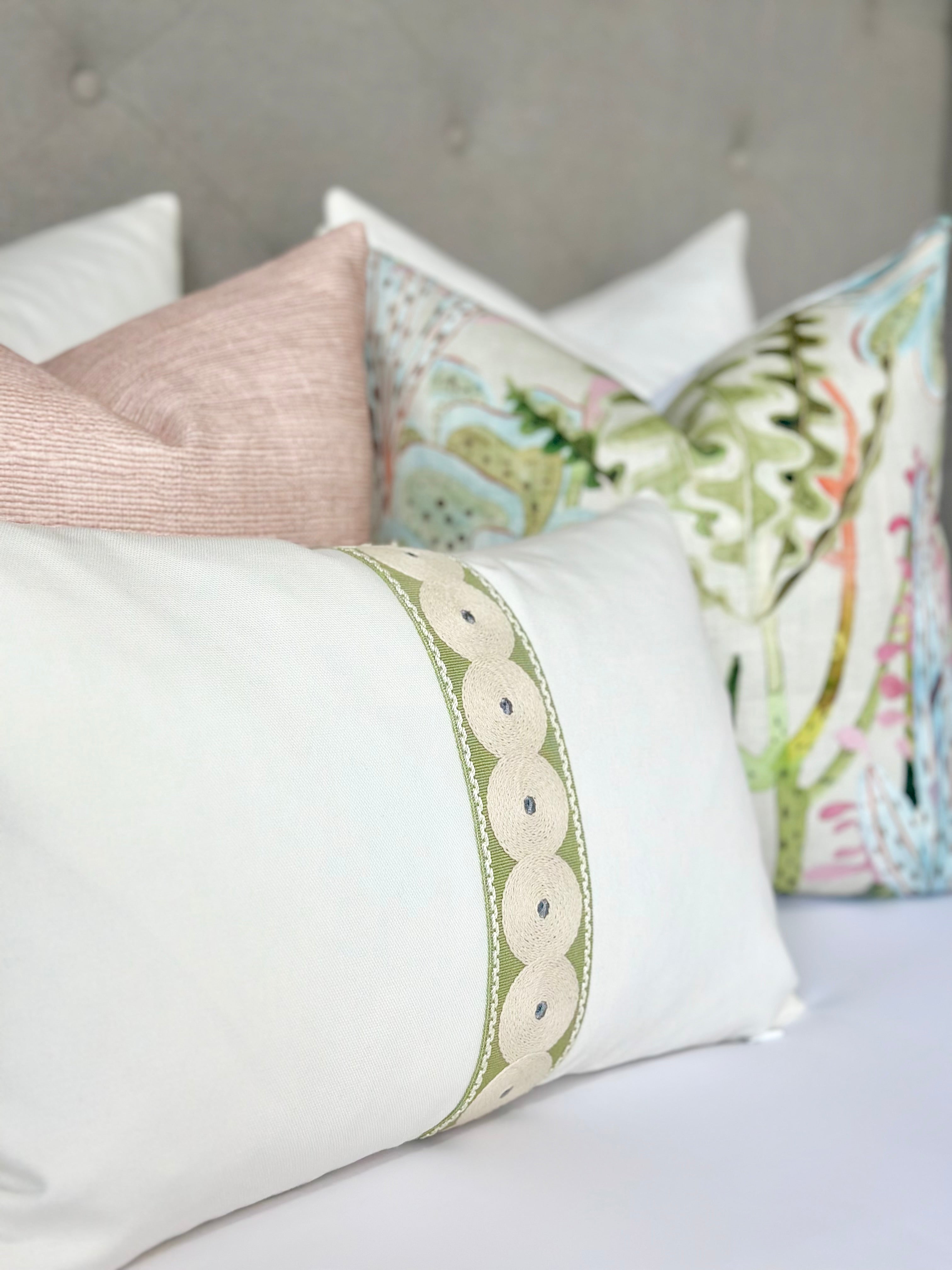 Custom white cotton canvas pillow cover with olive green decorative tape and beige thread circles, ideal for modern interiors. This handmade pillow features a striking contrast design and an invisible zipper for a seamless look, perfect for adding a touch of elegance to any living room or bedroom