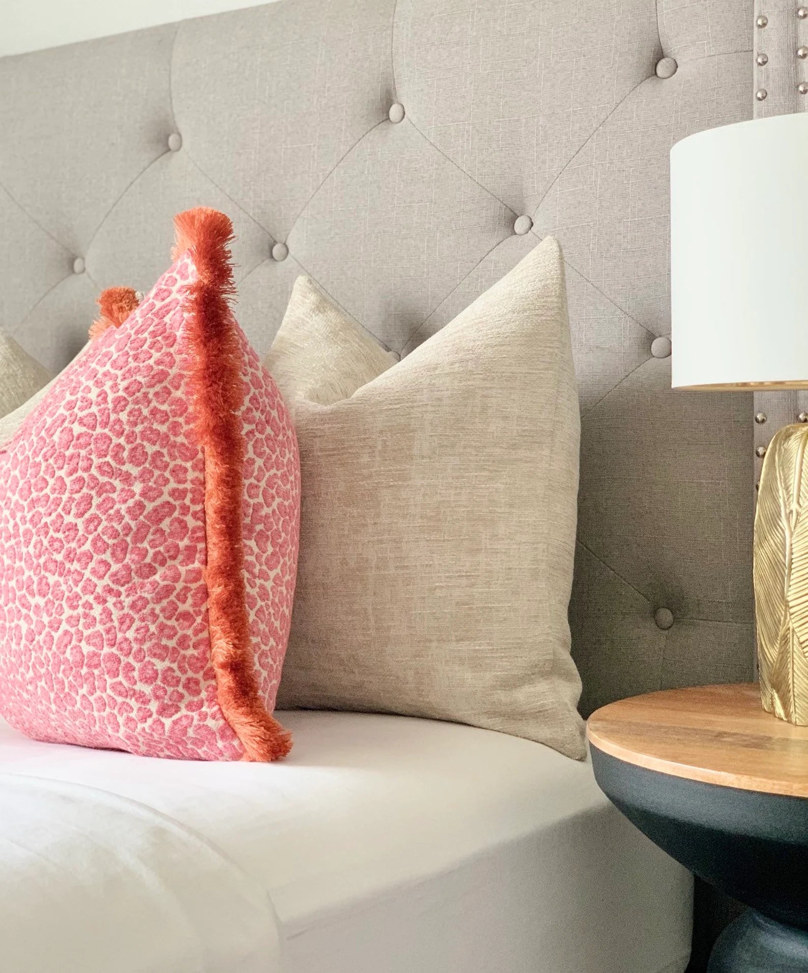 Luxurious pink cheetah pillow with vibrant orange fringe detail - unique, made-to-order designer throw pillow for elegant and contemporary chinoiserie interiors 